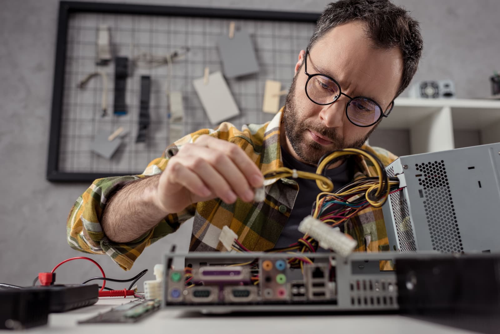 man-adjusting-details-while-fixing-computer-2024-11-13-14-42-55-utc.jpg